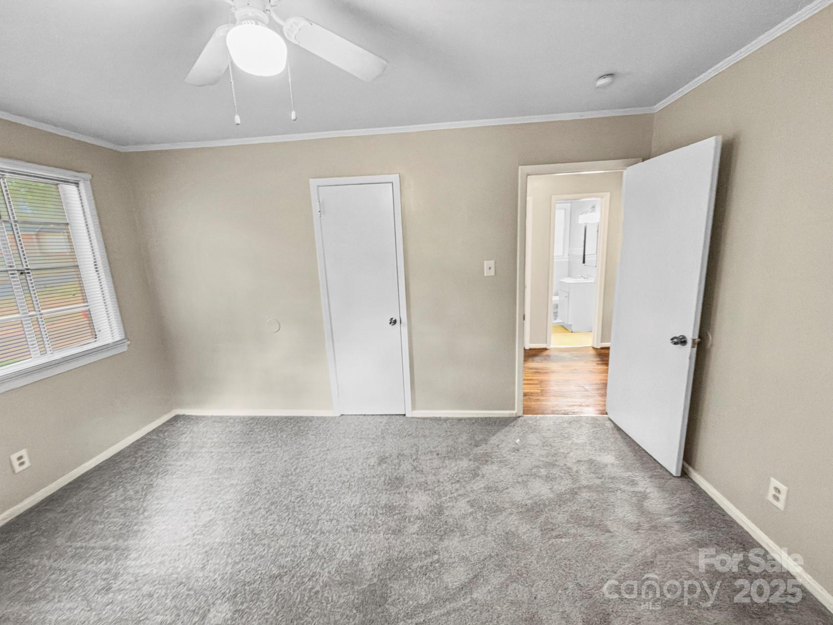 3014 Marlborough Road Charlotte, NC 28208 - Photo 7 of 20 wooden floor in an empty room with a window