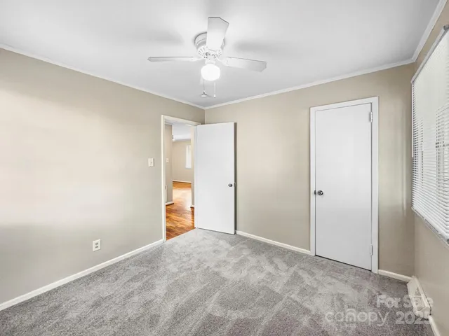 a view of an empty room with a ceiling fan
