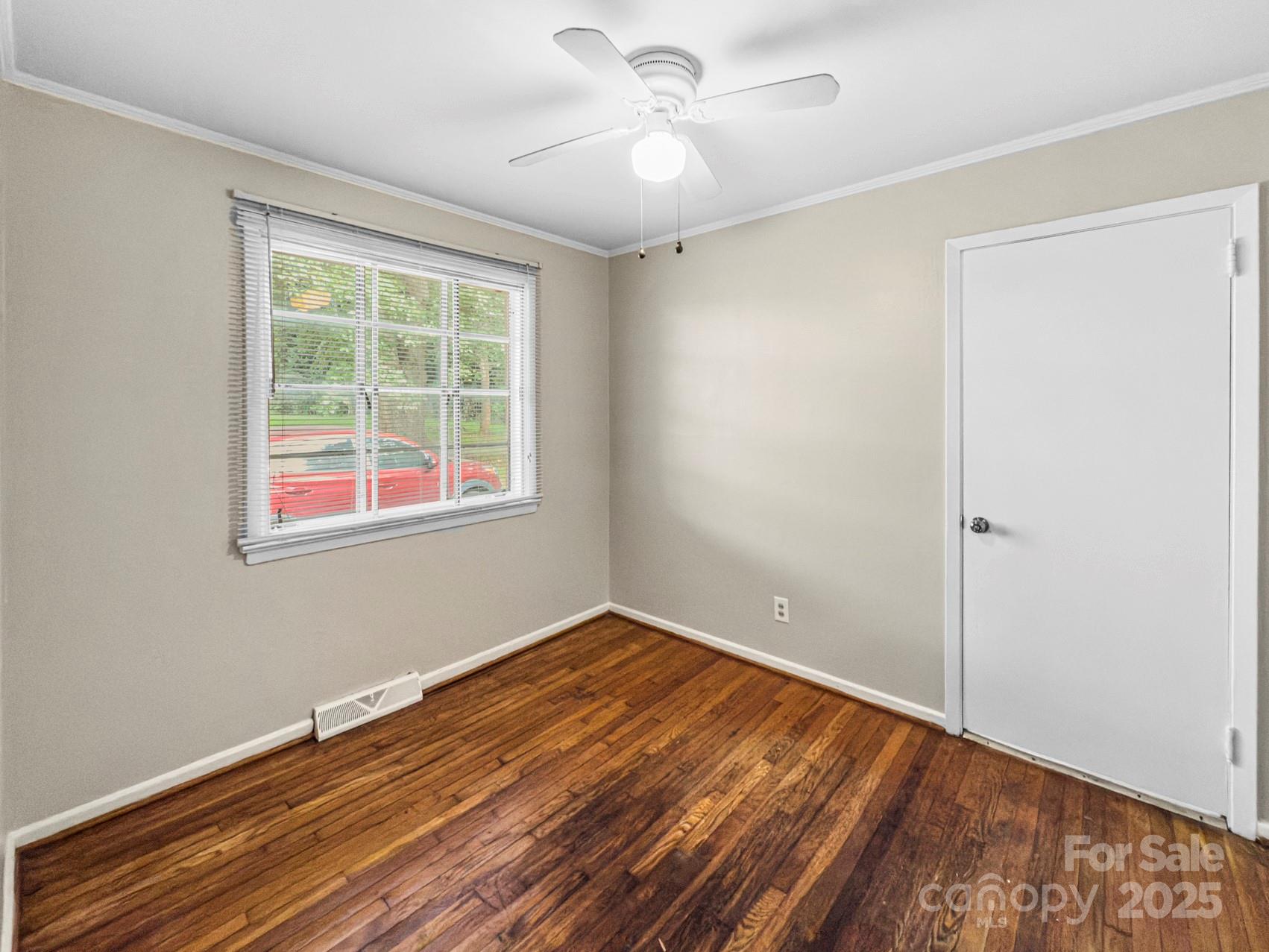 3014 Marlborough Road Charlotte, NC 28208 - Photo 10 of 20 a view of empty room with wooden floor and fan