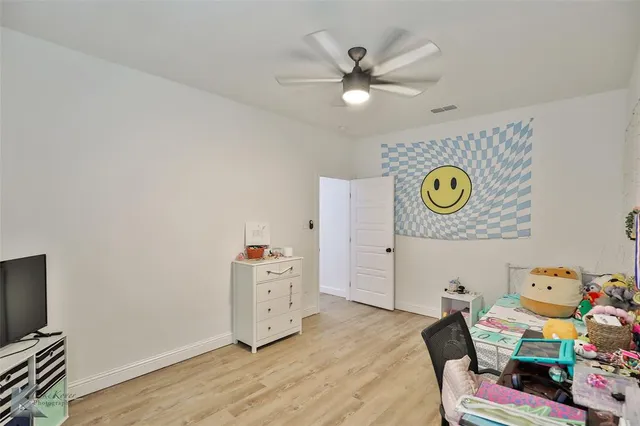 a bedroom with a bed and ceiling fan