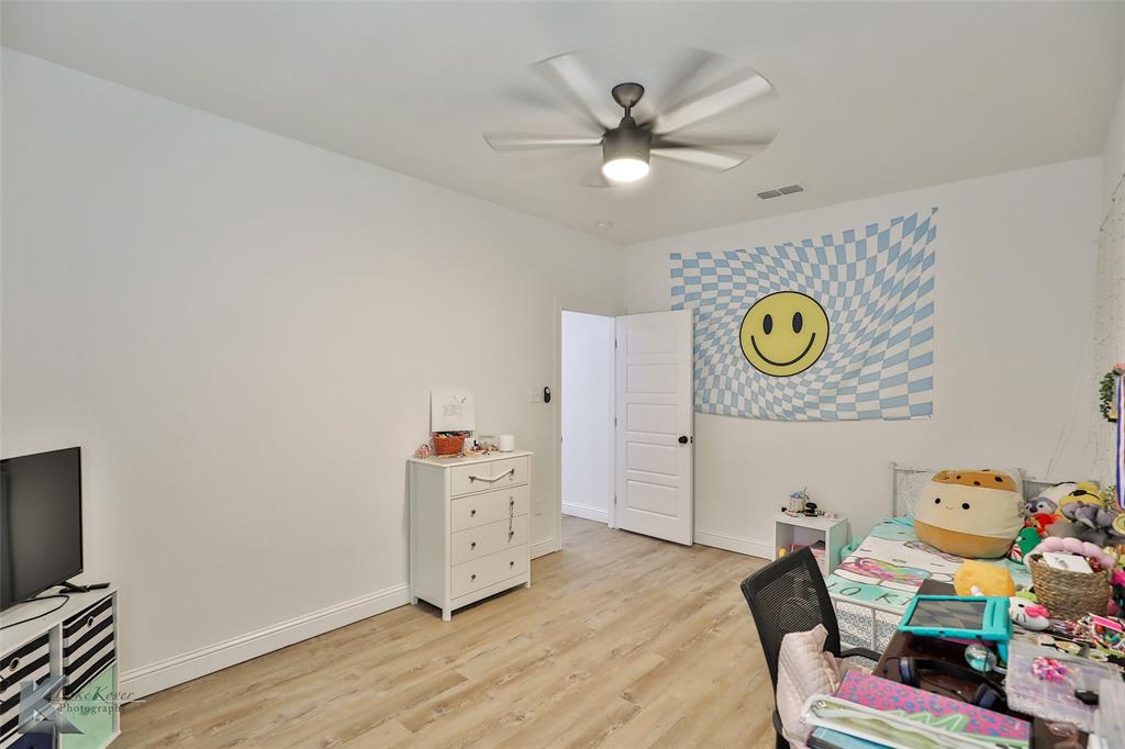 243 Beechcraft Abilene, TX 79602 - Photo 18 of 33 a bedroom with a bed and ceiling fan