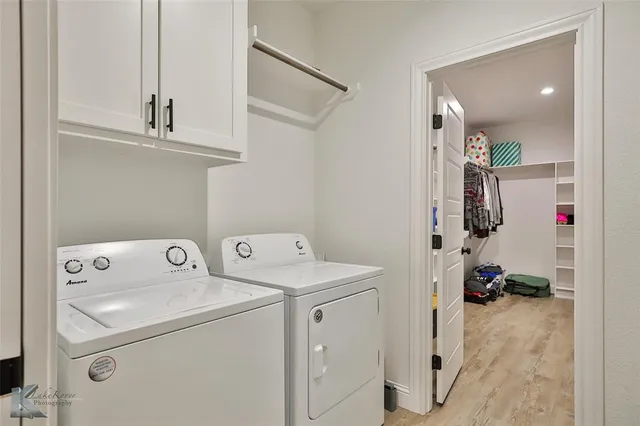a view of storage and utility room with washer and dryer