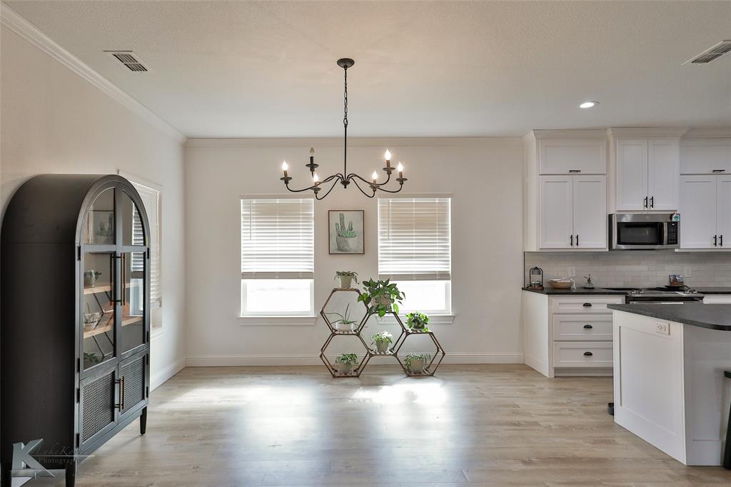243 Beechcraft Abilene, TX 79602 - Photo 4 of 33 a view of a kitchen with furniture a potted plant and wooden floor