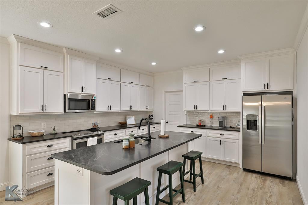 243 Beechcraft Abilene, TX 79602 - Photo 5 of 33 a kitchen with stainless steel appliances granite countertop a sink a stove a refrigerator and cabinets