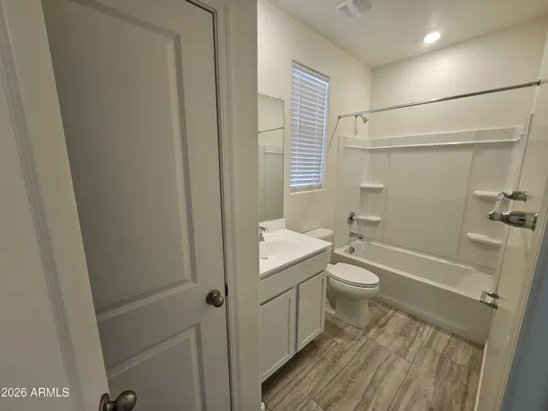 a bathroom with a granite countertop toilet a sink and bathtub