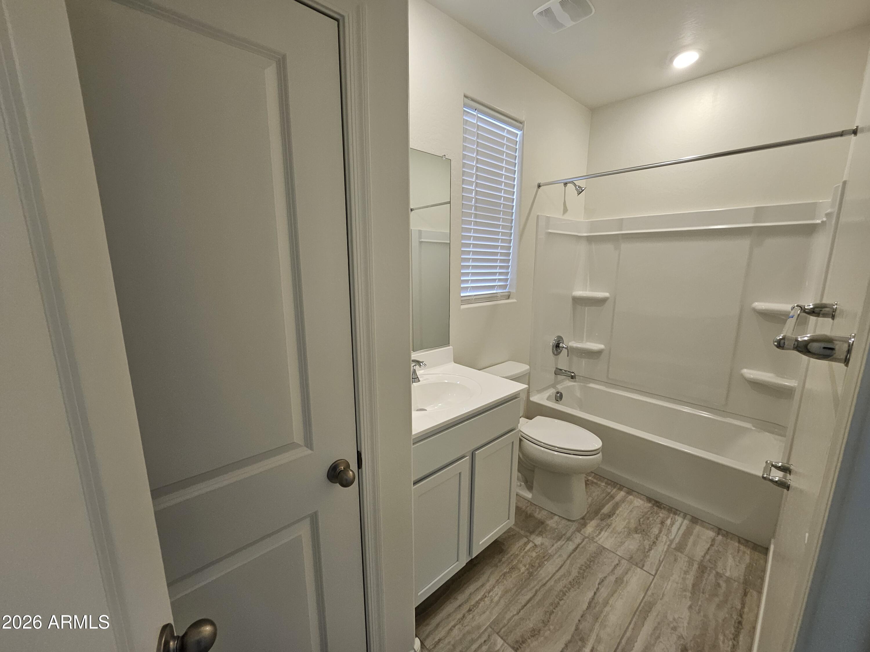 3010 East Augusta Avenue Gilbert, AZ 85298 - Photo 13 of 33 a bathroom with a granite countertop toilet a sink and bathtub