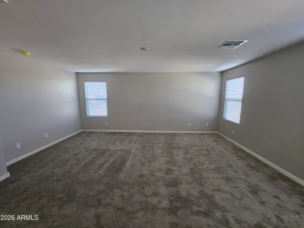 an empty room with a empty space and windows