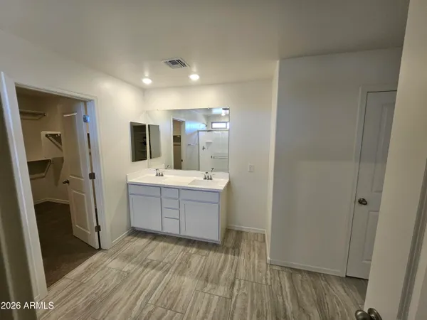a bathroom with a sink vanity granite tub and shower