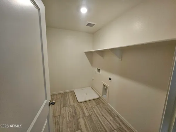 an empty room with wooden floor