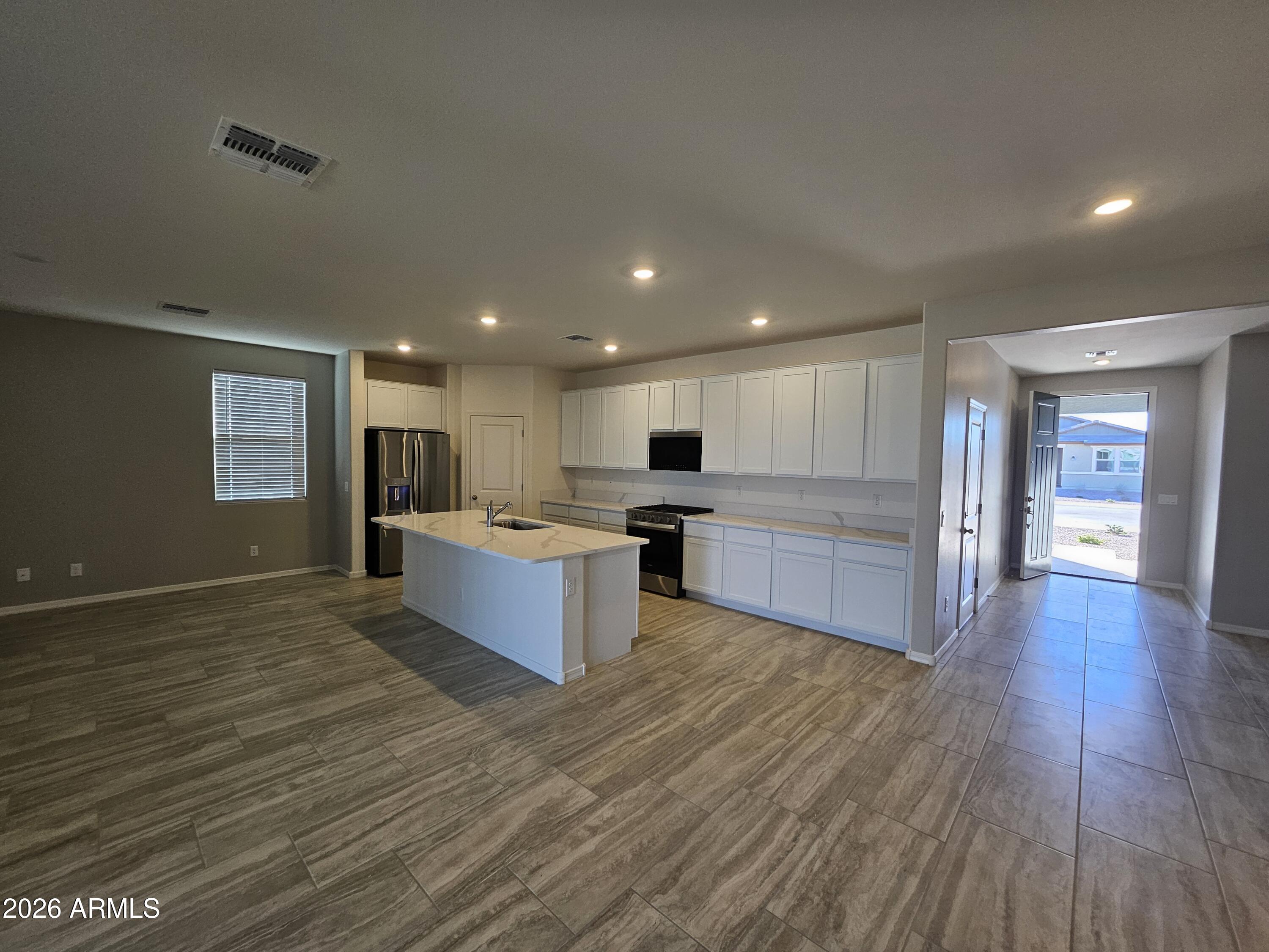 3010 East Augusta Avenue Gilbert, AZ 85298 - Photo 3 of 33 a large kitchen with stainless steel appliances granite countertop a large counter top a stove and a wooden floors
