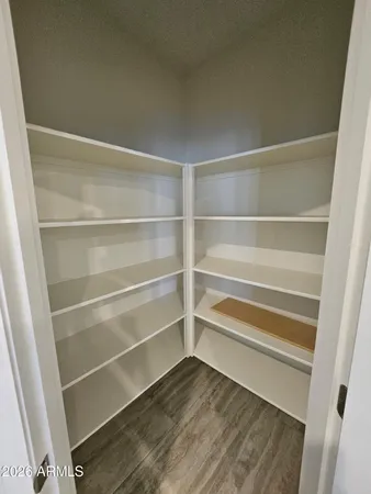 a view of walk in closet with empty racks