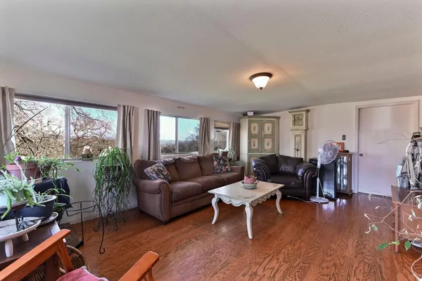 a view of an entryway with wooden floor