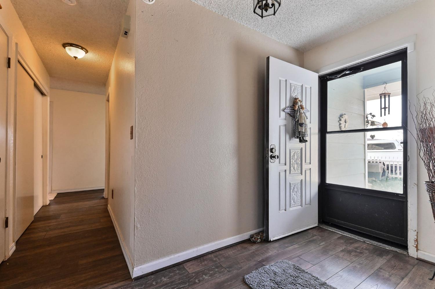 3653 Chuckwagon Drive Copperopolis, CA 95228 - Photo 19 of 73 a view of a hallway with wooden floor and windows