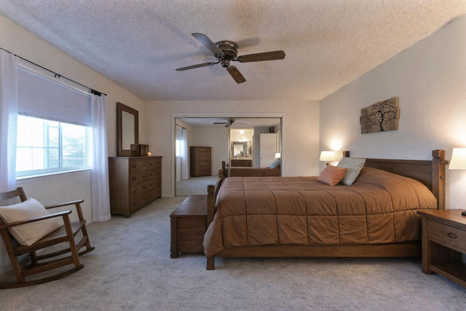 3653 Chuckwagon Drive Copperopolis, CA 95228 - Photo 21 of 73 a bedroom with a bed and a chandelier