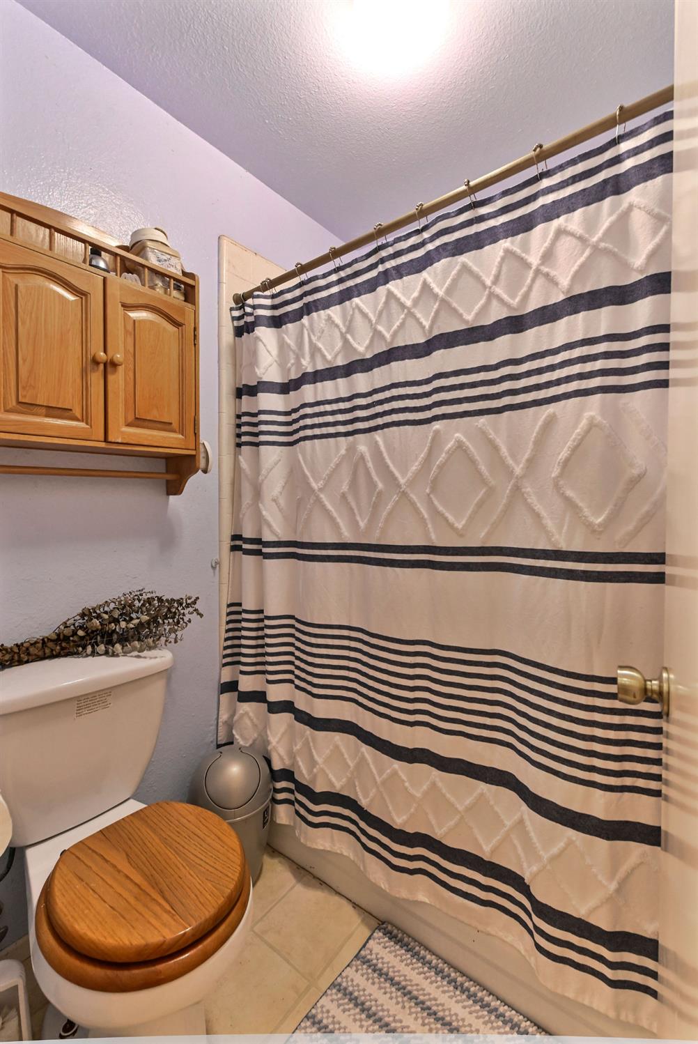 3653 Chuckwagon Drive Copperopolis, CA 95228 - Photo 26 of 73 a bathroom with a toilet a sink and a mirror