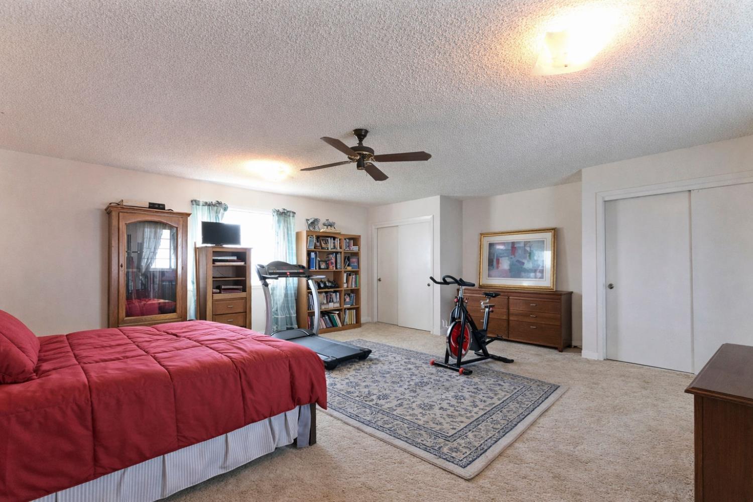 3653 Chuckwagon Drive Copperopolis, CA 95228 - Photo 32 of 73 a bed room with a bed and a chandelier