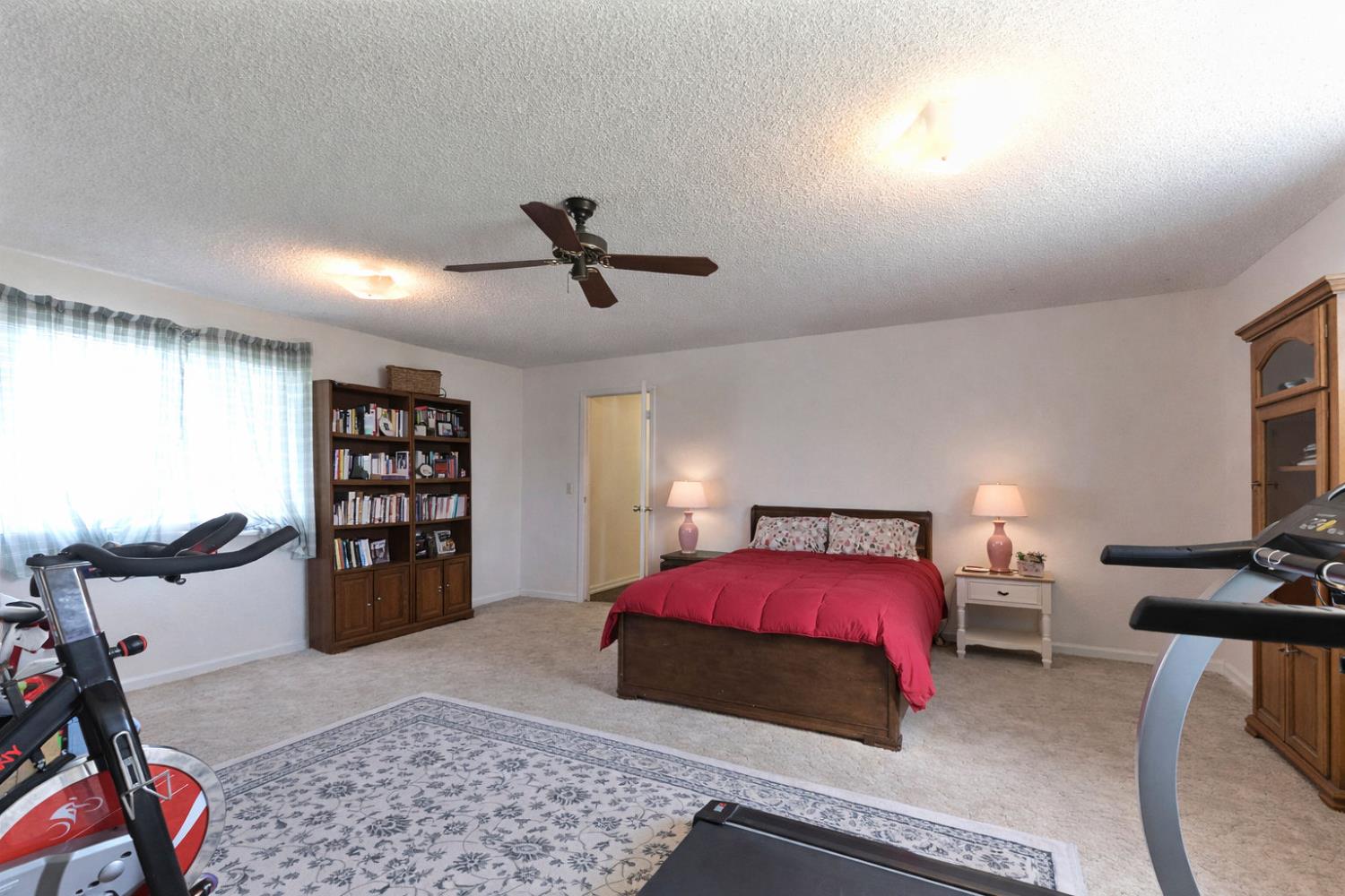 3653 Chuckwagon Drive Copperopolis, CA 95228 - Photo 33 of 73 a bedroom with a bed a dresser and many windows