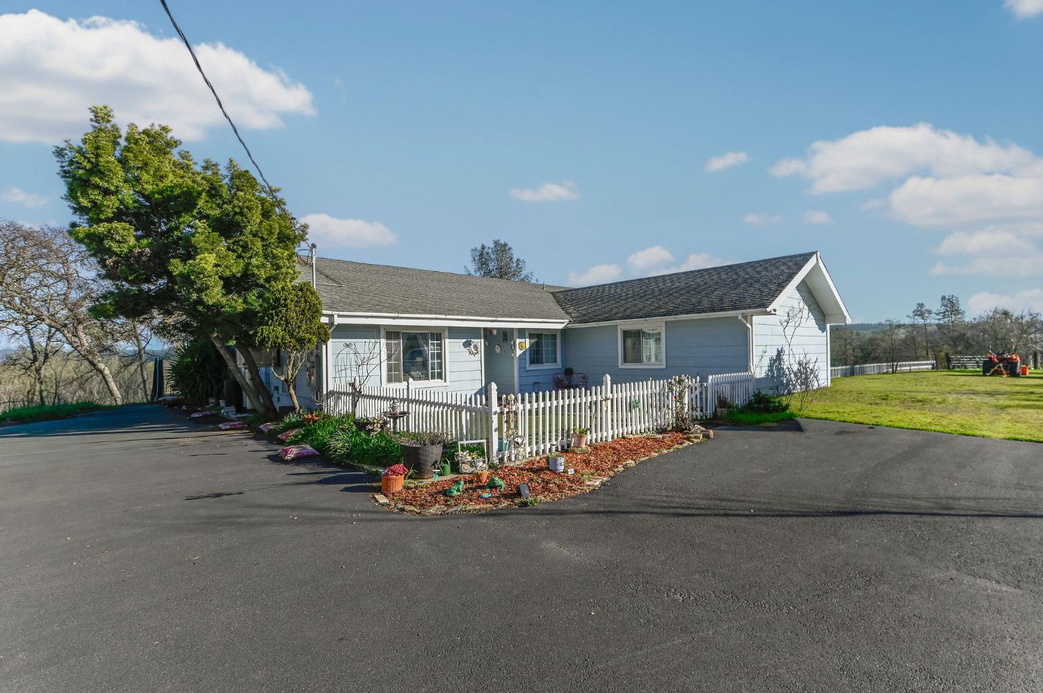 3653 Chuckwagon Drive Copperopolis, CA 95228 - Photo 34 of 73 a front view of a house with a yard and garage