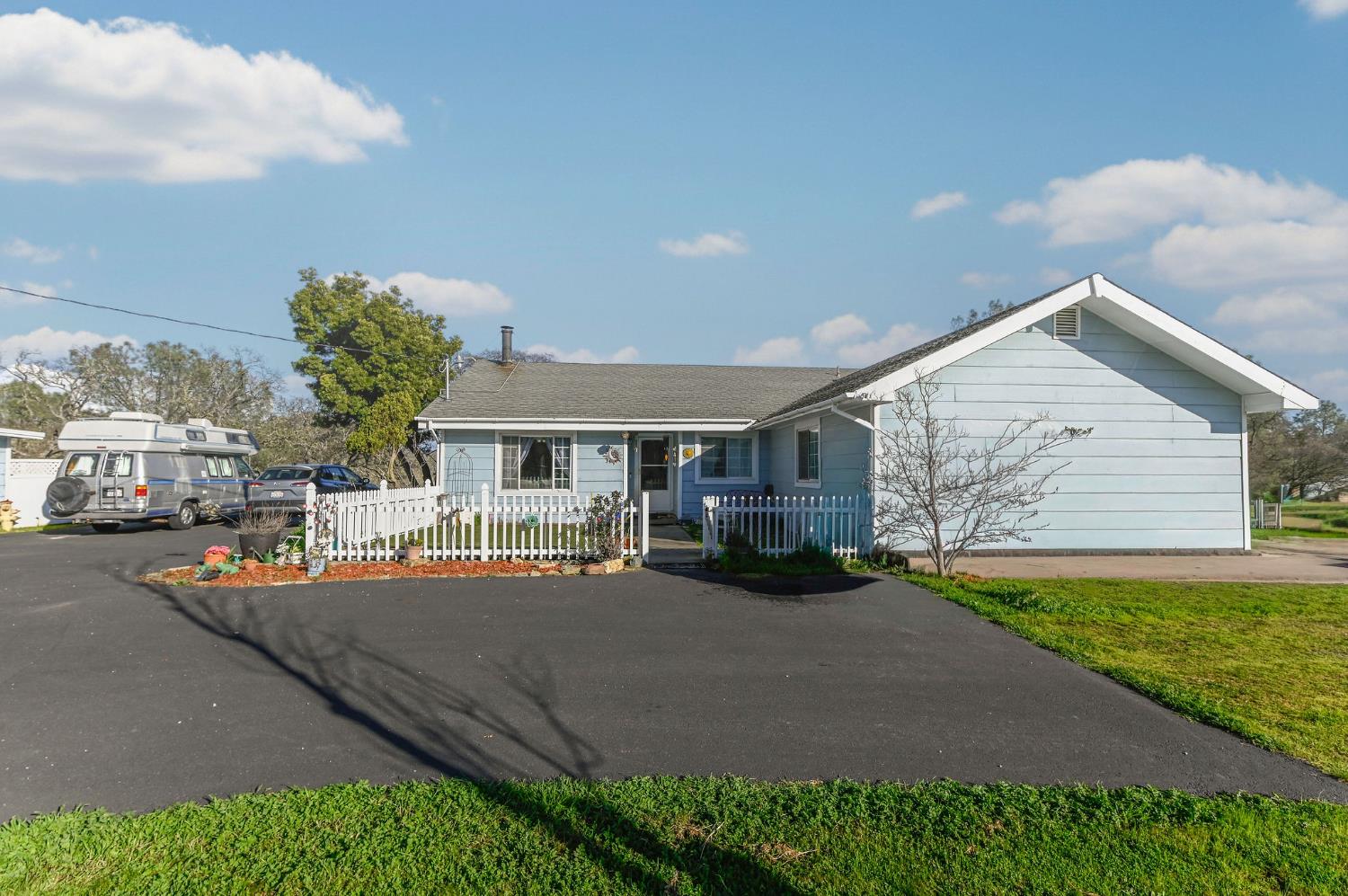 3653 Chuckwagon Drive Copperopolis, CA 95228 - Photo 35 of 73 a front view of a house with a yard and a garage