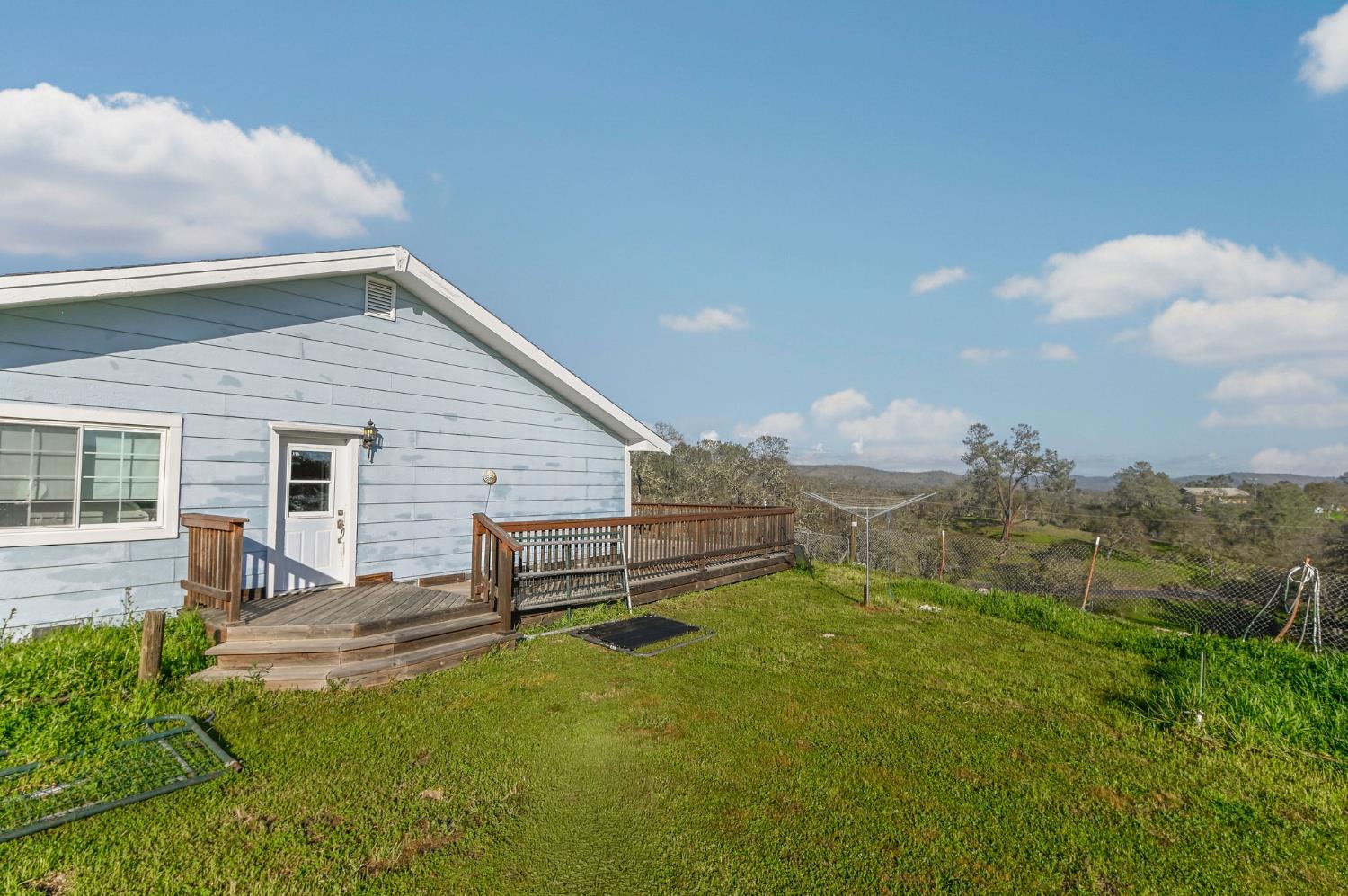 3653 Chuckwagon Drive Copperopolis, CA 95228 - Photo 38 of 73 a view of a backyard with table and chairs and wooden fence