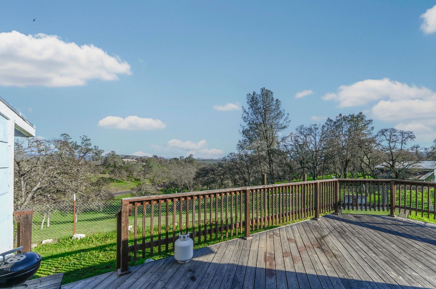 3653 Chuckwagon Drive Copperopolis, CA 95228 - Photo 40 of 73 a view of a roof deck with wooden floor and fence