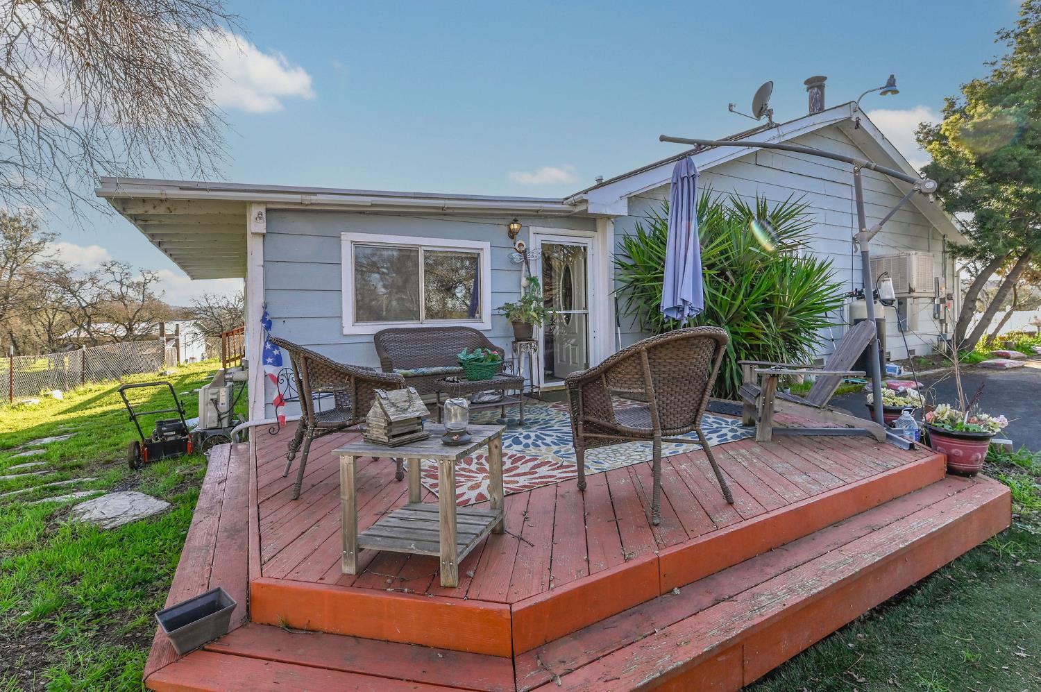 3653 Chuckwagon Drive Copperopolis, CA 95228 - Photo 45 of 73 a view of a patio with table and chairs potted plants and a large tree