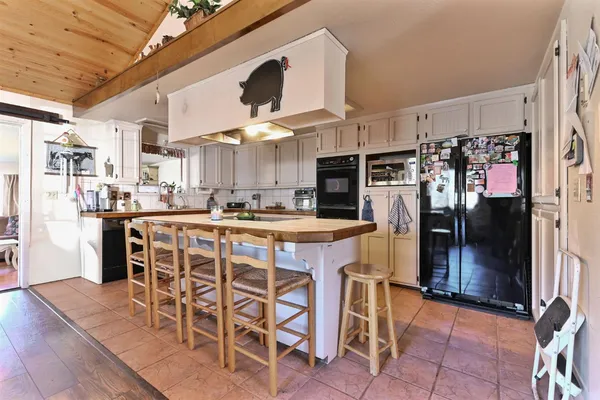 a kitchen with stainless steel appliances granite countertop a sink and a refrigerator