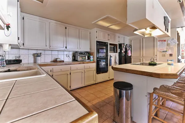 a kitchen with a sink cabinets and window