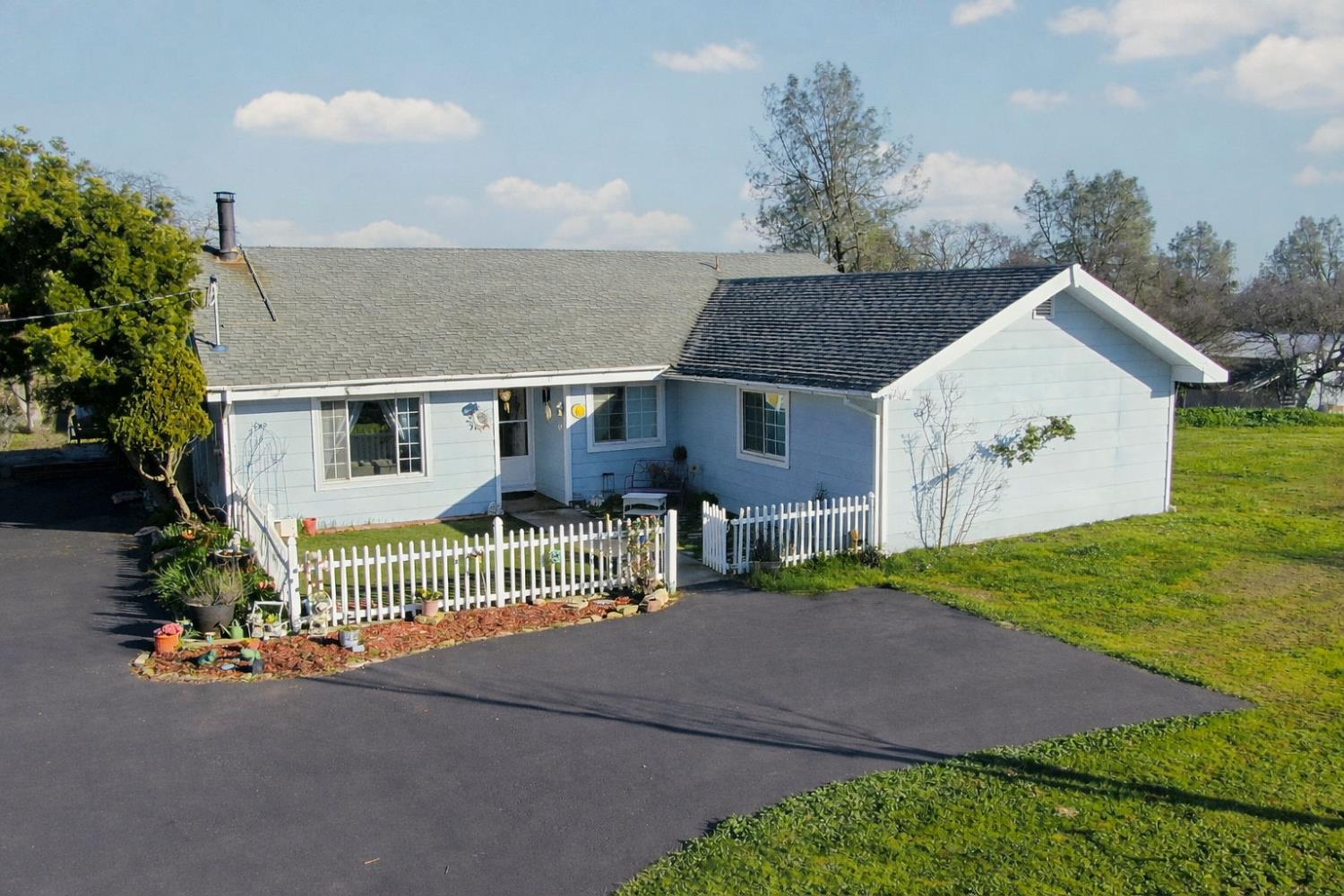 3653 Chuckwagon Drive Copperopolis, CA 95228 - Photo 67 of 73 a front view of a house with a garden and plants