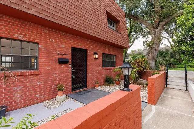 a backyard of a house with outdoor seating