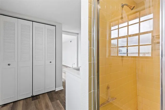 a bathroom with a sink a toilet a mirror and shower