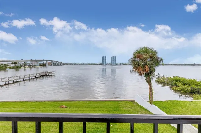 a view of a swimming pool with a yard and lake view in back