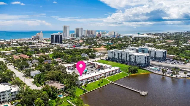 a view of a house with a yard porch and a tree
