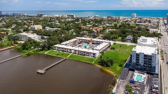 a view of a patio with table and chairs and potted plants