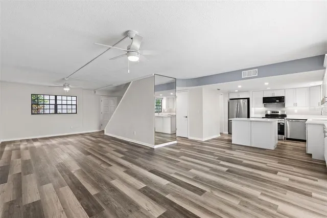a kitchen with white cabinets and sink