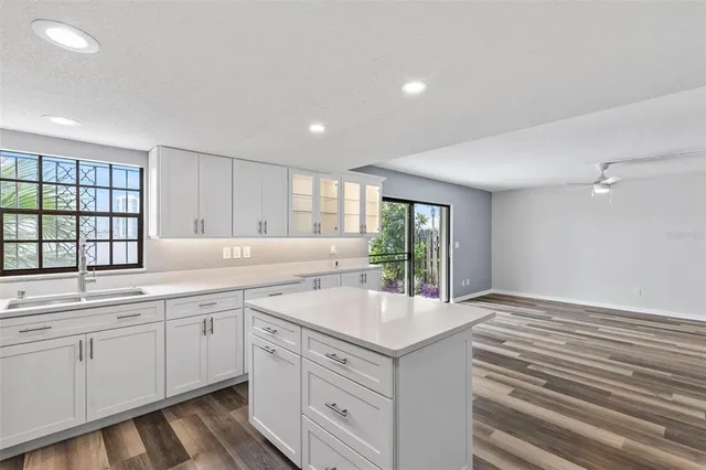 a kitchen with a sink stainless steel appliances and cabinets
