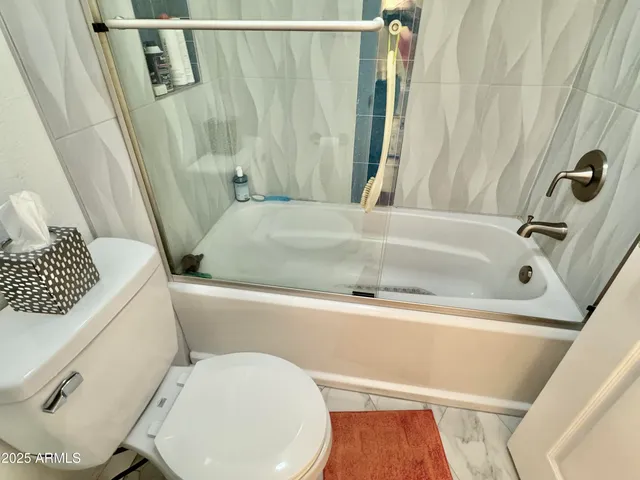 a kitchen with a sink and toilet