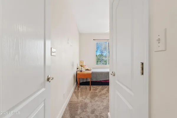 a view of a bedroom with a bed and a window