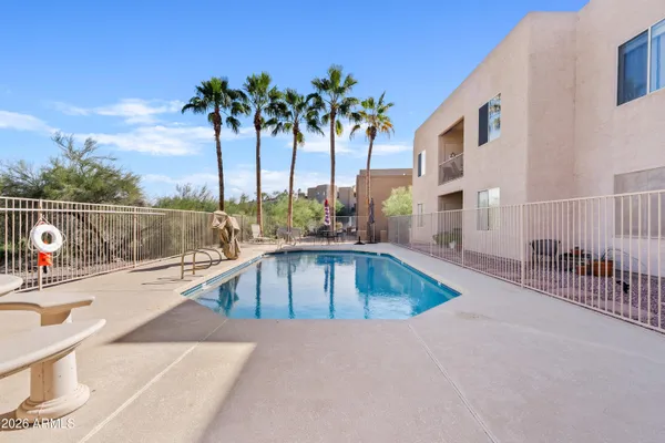 a view of a swimming pool with a lounge chair