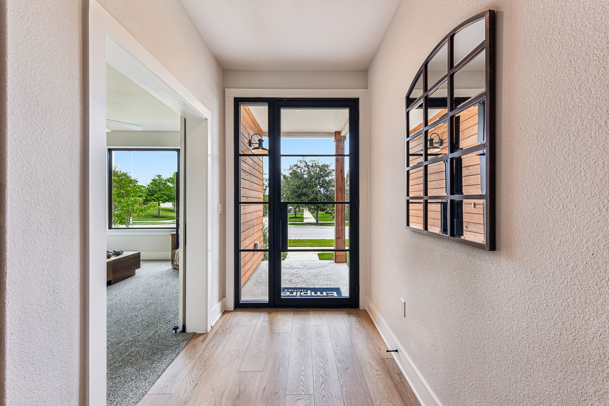 9033 Cattle Baron Path Austin, TX 78747 - Photo 6 of 40 A welcoming entry featuring abundant natural light and wood flooring.