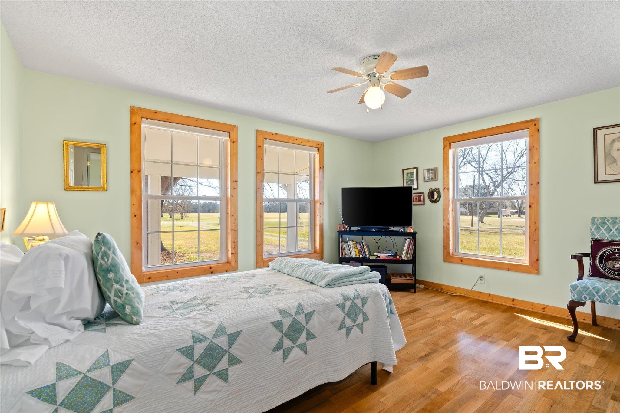14280 Cat Deakle Road Grand Bay, AL 36541 - Photo 17 of 51 Bedroom featuring light wood-type flooring, a ceiling fan, baseboards, and a textured ceiling