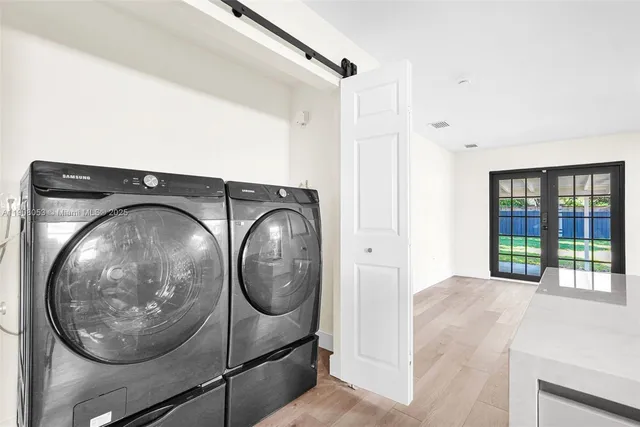 a view of a hallway with washer and dryer