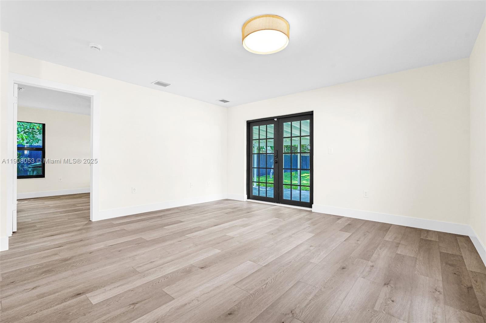 136 Northwest 53rd Street Miami, FL 33127 - Photo 13 of 28 a view of an empty room with wooden floor and a window