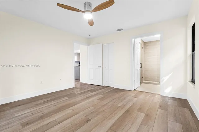 a view of an empty room with wooden floor