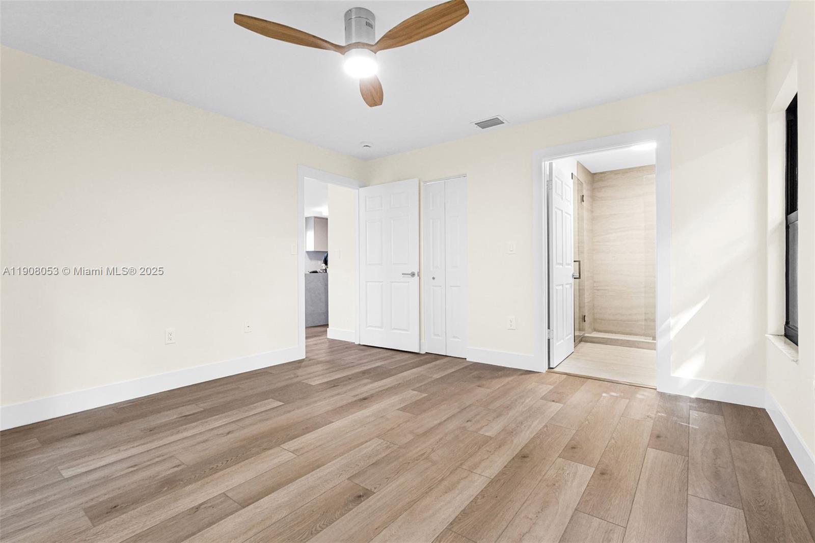 136 Northwest 53rd Street Miami, FL 33127 - Photo 14 of 28 a view of an empty room with wooden floor