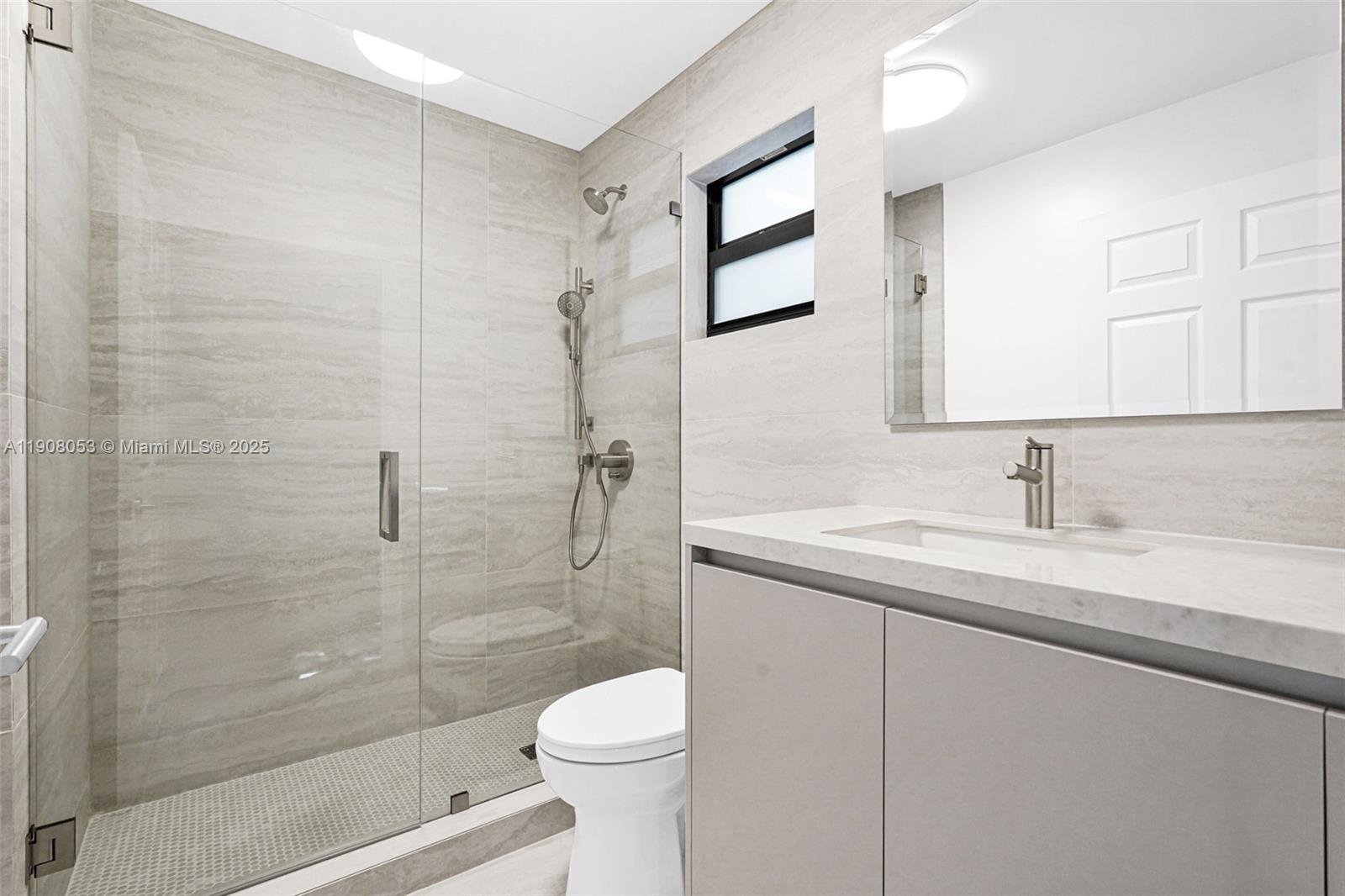 136 Northwest 53rd Street Miami, FL 33127 - Photo 16 of 28 a bathroom with a sink a toilet and shower