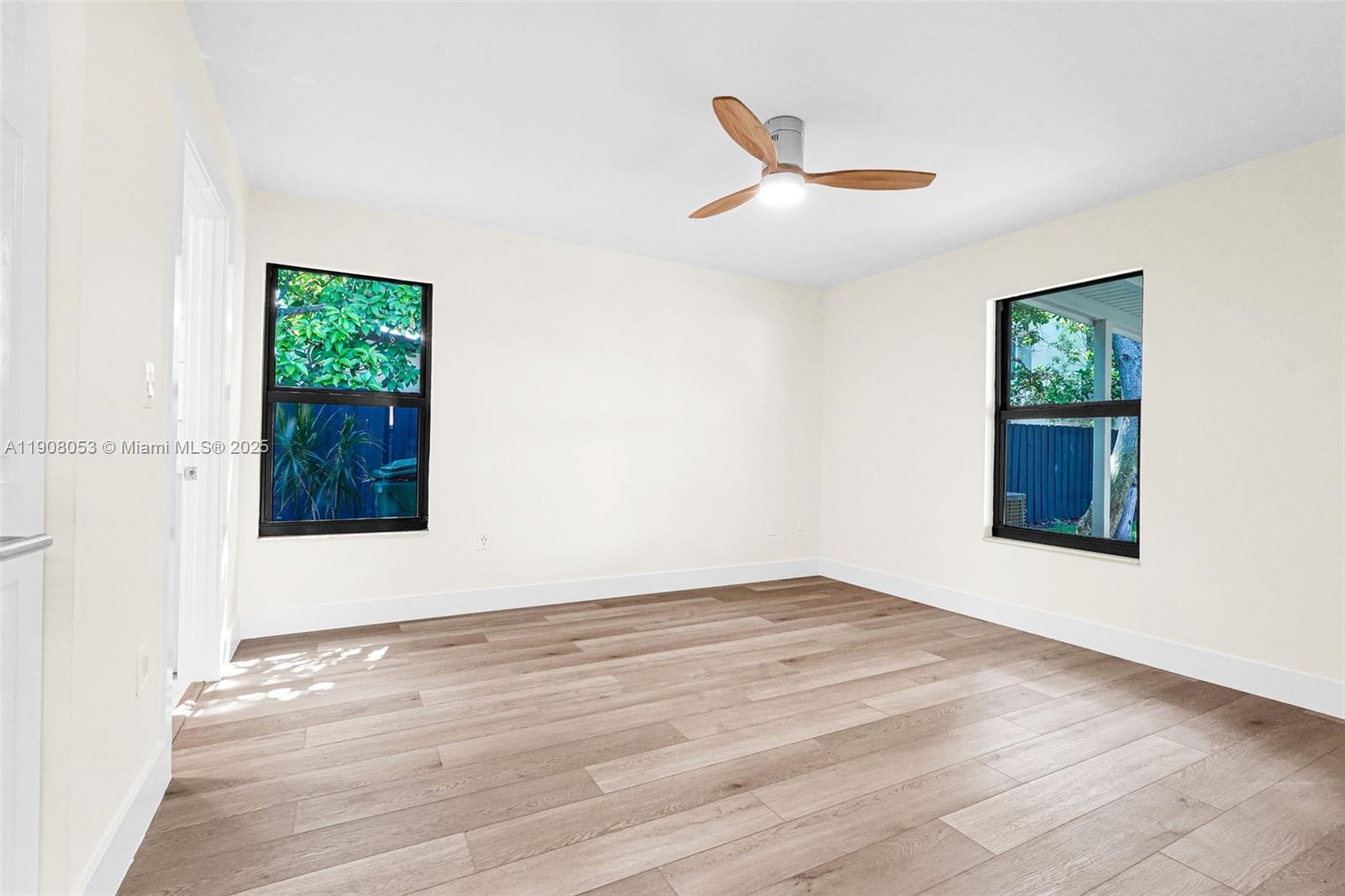 136 Northwest 53rd Street Miami, FL 33127 - Photo 17 of 28 a view of an empty room with wooden floor and a window