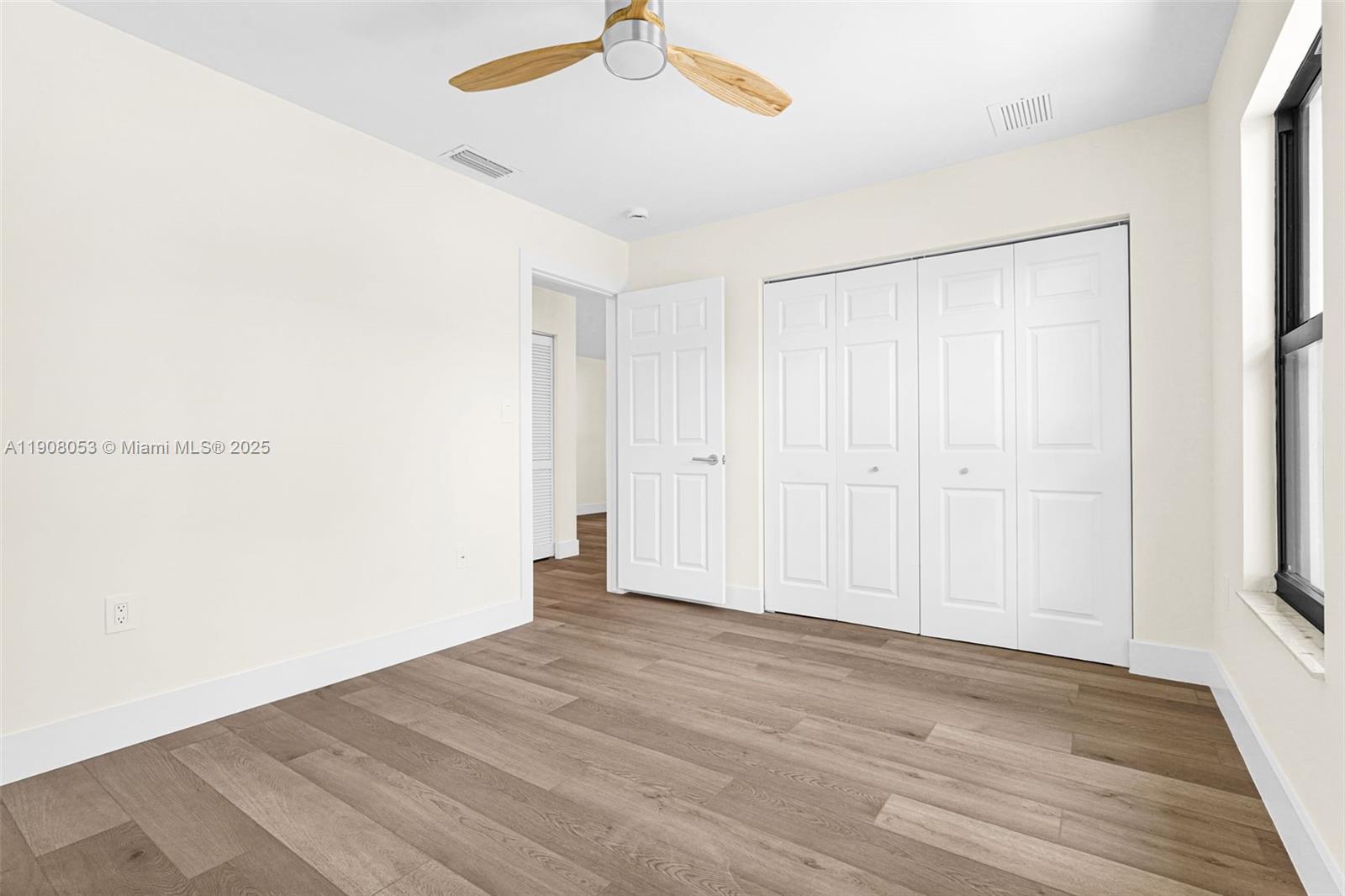 136 Northwest 53rd Street Miami, FL 33127 - Photo 22 of 28 a view of an empty room with wooden floor