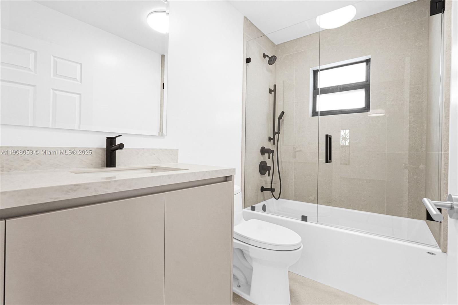 136 Northwest 53rd Street Miami, FL 33127 - Photo 23 of 28 a bathroom with a sink a toilet and shower