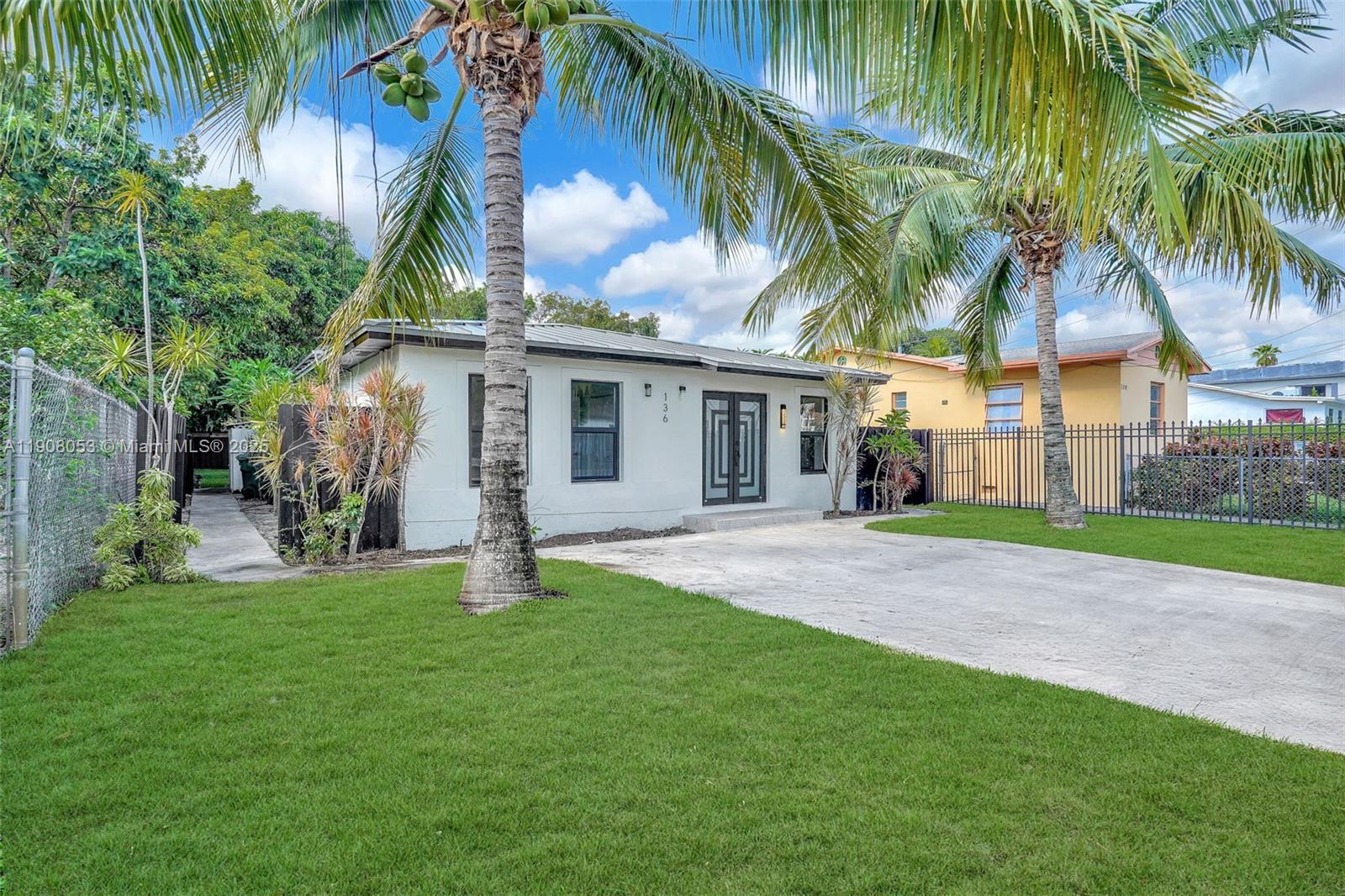 136 Northwest 53rd Street Miami, FL 33127 - Photo 24 of 28 a house with palm tree in front of it